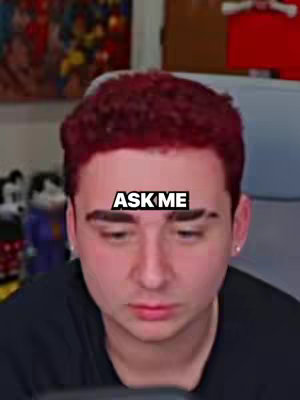 A close-up shot of a young man with red hair looking directly at the camera, with a text overlay on his forehead.