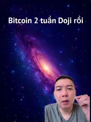 The cover image features a man centered in the frame, against a backdrop of a vibrant galaxy with swirling colors. Above the man, text in white font reads, 'Bitcoin 2 tuần Doji rồi'. The man appears to be looking directly at the camera, likely speaking about the topic.