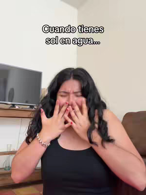 The cover image shows a young woman in a black tank top, her face obscured as she covers it with her hands, seemingly in distress or emotional expression. Above her head, a text overlay reads in white text with a black background. The setting appears to be indoors, with a beige wall in the background where most of the light is.