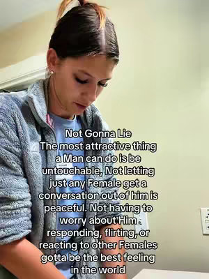 The image shows a woman in a blue jacket facing slightly downwards. She has her hair up in a ponytail and is looking toward the camera. The text overlay in a white box covers almost everything, the text is not fully visible but easy to read.