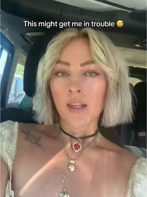 A woman with light skin and blonde hair with a center part is in the driver's seat of a car. The text overlay indicates that the creator is aware that the content may result in consequences.