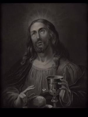 Monochrome image of Jesus with long hair and beard, looking upwards. He holds a chalice in one hand and what appears to be a piece of bread in the other. A halo surrounds his head.