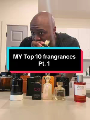 A man, lit by overhead lighting, holds a perfume bottle by his nose. In front of him are a collection of perfume bottles on a white counter, and below his face is a teal and black rectangular box showing text.