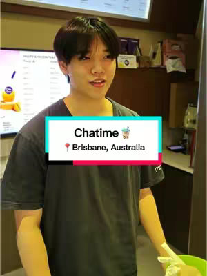 A young man stands in front of a counter, likely at a Chatime location. He is wearing a dark gray t-shirt. A text overlay at the center shows "Chatime" and "Brisbane, Australia."