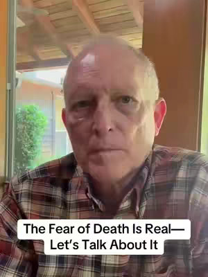 A medium shot of an older, light-skinned man with short, thinning hair. He's wearing a plaid shirt and looking directly at the camera with a serious expression. The background includes an out-of-focus window and parts of a wooden ceiling. Text overlayed on the bottom of the screen reads, 'The Fear of Death Is Real—Let's Talk About It'.