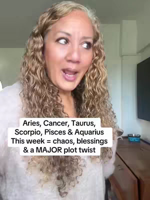 A woman with long, curly hair and makeup is centered in the frame with text overlays. She is looking off to the side with an open mouth, as though she is talking or surprised in front of a blurry background. The text is white against a semi-transparent black background.