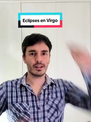 A man with dark hair and a beard is centered in the frame. He wears a plaid shirt and is looking at the camera with a slightly concerned expression. A rectangular text overlay reading "Eclipses en Virgo" sits above his head, with a black background and red and blue accents.