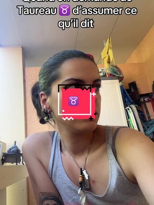 A woman is seen from the chest up, with a messy bun, earrings, and a necklace standing in a room with off-white walls. The cover image has text overlay.