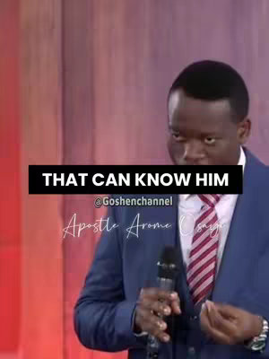 A man in a suit standing in what appears to be a church hall or stage holding a microphone with a black banner over his head that read: 'THAT CAN KNOW HIM' with additional text below the banner reading '@Goshenchannel Apostle Arome Osaye'