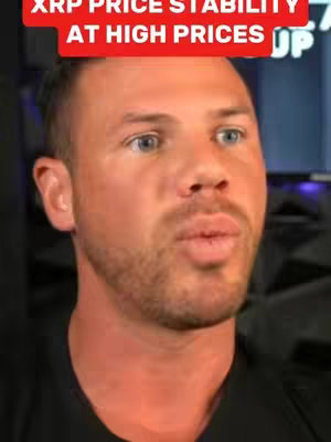 A close-up shot of a fair-skinned man with short, light brown hair and a trimmed beard. He looks directly at the camera, with a slight pursing of the lips as if speaking. Above him is a red banner with white text that reads "XRP PRICE STABILITY AT HIGH PRICES".