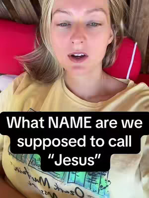 The image features a fair-skinned woman with blonde hair, looking directly at the camera with a neutral expression. She appears to be lying down, with red items (possibly pillows or cushions) behind her. The background is slightly out of focus. A black text overlay states: "What NAME are we supposed to call "Jesus"". The overall composition is close-up, focusing on the woman's face and the overlaid text.