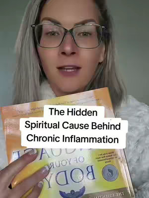 A woman with gray hair wearing glasses holds a book in front of her with overlaid text. The background is blurred, and the overall composition focuses on the woman and the book.