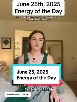 A woman with long brown hair stands indoors, facing the camera in front of a bed. She's wearing a green top, and the background suggests a room with a window and a painting.