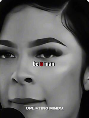 A black and white close-up of a woman's face, slightly angled. The background and her features are softly lit. The text overlay "be a man" appears in the center.