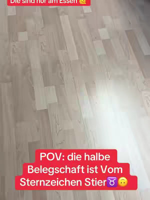 The image shows a wooden floor with a red bar at the top that has white text in it. The bar below it has a similar design and text.