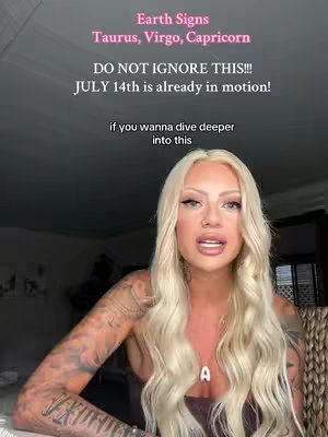 A woman with long blonde hair and tattoos on her arms is centered in the frame, speaking directly to the camera. Text overlays at the top provide context, reading 'Earth Signs Taurus, Virgo, Capricorn' and further prompts. The background is a soft, neutral tone, with the lighting appearing natural. The composition focuses on the woman's face and upper body, creating an intimate feel.