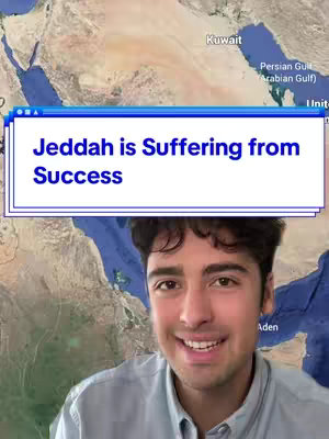 The cover image features a smiling young man framed from the chest up. He is positioned against a background that appears to be a map, with the text "Jeddah is Suffering from Success" displayed in a stylized bubble above his head in a retro-style user-interface element. The man is wearing a light blue button-down shirt and his expression is engaging. The background map has land and some water features, appearing to be a satellite view of the area or a geographical representation.