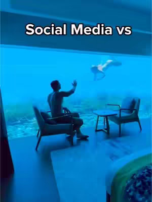 The cover image showcases a luxurious, underwater-themed setting with a man in the foreground and a person in the background. The water gives off a blue hue. The man is seated in a chair, looking toward a person swimming in the water outside a large window.