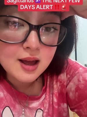 A selfie-style shot focused on a woman's face. She's wearing large, black-rimmed glasses and a pink, tie-dye style shirt. Her expression is one of surprise, with her mouth slightly open. Above her is a red banner with white text.