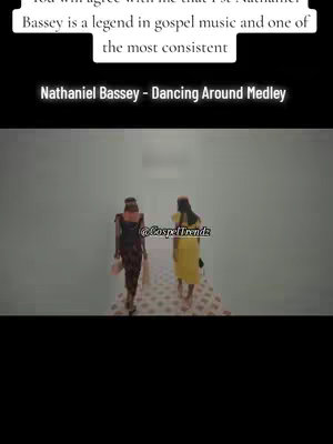 The cover image shows two women walking towards the camera, presumably on a decorated path. Above them is overlaid text with the song title and artist. The background is a simple, light-colored gradient, which emphasizes the figures walking in the foreground.