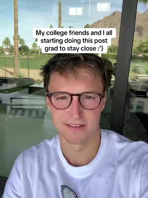 A man with glasses smiles and looks at the camera. Overlay text reads 'My college friends and I all starting doing this post grad to stay close :)'. The background includes a window and outdoor scenery.