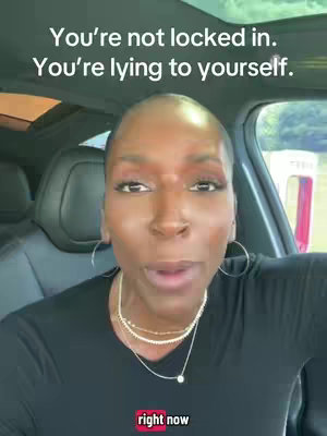 A woman with short hair is speaking directly to the camera while seated in a car, with text overlayed in the top of the image.