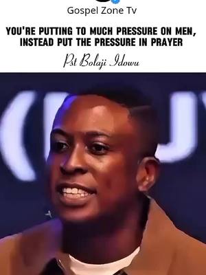 A man with short, dark hair and a light brown jacket is centered in the image, speaking into the camera. Above him, text overlayed on a dark background states a message and the speaker's name, 'Pst Bolaji Idowu.' The background behind the man has a blurred effect and is a darker shade of blue.