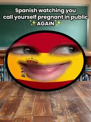 A humorous cover image features a circular design incorporating the flag of Spain. The central element is an animated face with human eyes and a mouth, expressing a mixture of amusement and slight judgment. Above the flag, a caption reads, "Spanish watching you," while an additional line indicates the subject of the video. The background shows a blurry classroom setting with a chalkboard and wooden desks to the sides of the image.