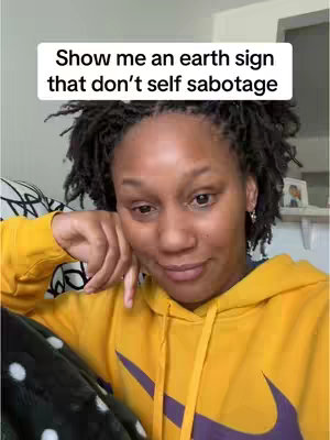 A woman with locs wearing a yellow Nike hoodie looks towards the camera, resting her chin on her hand. A text overlay appears above her head in a white box.