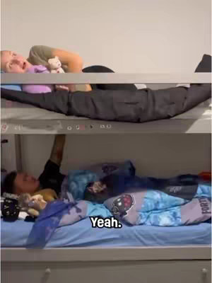 The image shows a split-level bunk bed. The top bunk has a person lying down. The lower bunk shows another person reaching up, and there is text overlaid at the bottom.