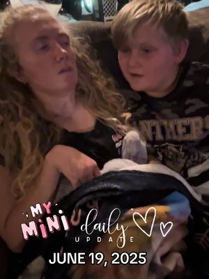 A photo shows a woman with long, curly blonde hair cradling a child. The woman looks tired, with her eyes closed or nearly closed. The child, with short blonde hair, is looking at the woman with concern. Overlay text reads 'MY MINI DAILY UPDATE' with the date 'JUNE 19, 2025'.