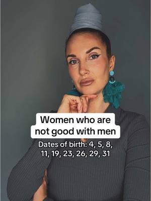 A woman with a light complexion and pulled-back dark hair looks directly at the viewer. She has dramatic, dark eye makeup and pale lipstick. She wears large, teal-colored dangly earrings and a dark, ribbed-knit top. A silver head wrap sits atop her head. A text overlay in a white box at the bottom of the frame reads: 'Women who are not good with men,' followed by a list of dates. The background is a solid, desaturated gray.