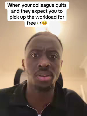 A man with dark skin and a low haircut stares directly at the camera with a concerned expression. Above him, text overlaid on the image reads a message about work. The lighting is soft, and the background appears to be indoors.