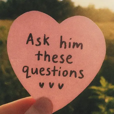 A hand holds a pink heart-shaped paper note with handwritten text against a blurry background of a natural setting, with a mix of green and golden colors.