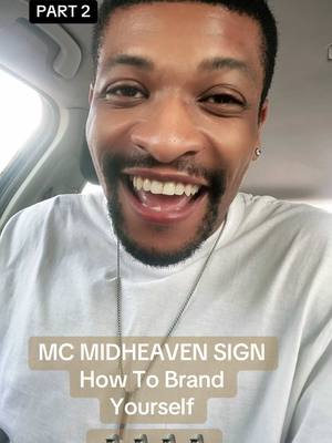 A selfie of a man smiling widely, with text overlays. He appears to be inside a vehicle, with his face taking up most of the frame. He is wearing a white shirt and a silver necklace. The background is blurry, but appears to be the inside of a car. The overlay text includes a title and a description about branding, with the part one in the corner.