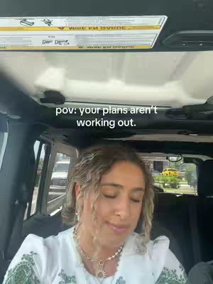 The video shows a woman in the driver's seat of a car, with the interior visible, the sky roof open, and sunlight streaming in. The woman's face is the focus, with an overlay text at the top.
