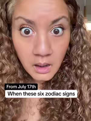 A close-up shot features a woman with light skin and curly, light brown hair. Her eyes are wide with a look of surprise or concern, and her mouth is slightly open, framing a neutral expression. There's text overlayed on the image, with one box at the bottom that reads "From July 17th", and another text box which reads "When these six zodiac signs".