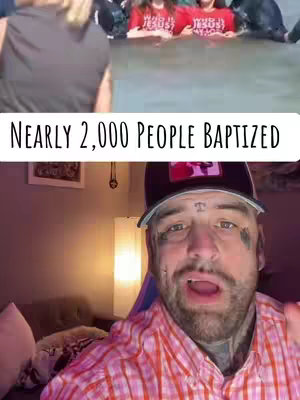 The image is divided into two sections. The bottom section features a man with facial tattoos, wearing a baseball cap, and a pink and white plaid shirt, looking directly at the camera and speaking. The background is a room with a lamp and what looks like a framed picture. The top section shows a split view: on the left, a person or people (blurred) and on the right, two people in red shirts are shown standing in water and are related to nearly 2,000 people baptized.