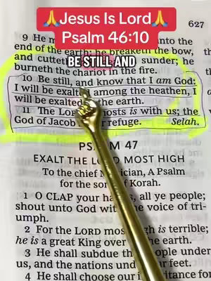 The image shows an open Bible with a highlighted verse and a golden hand-shaped tool pointing towards the passage. The text overlay 'Jesus Is Lord' in a red banner, along with the text Psalm 46:10 in a black banner. There are highlighted sections in yellow.