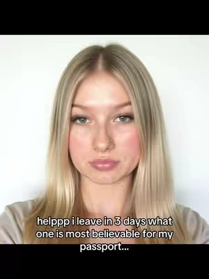 A close-up shot of a young woman with blonde hair, looking directly at the camera with a neutral expression. She has fair skin, light-colored eyes, and is wearing light makeup. The background appears to be plain white.
