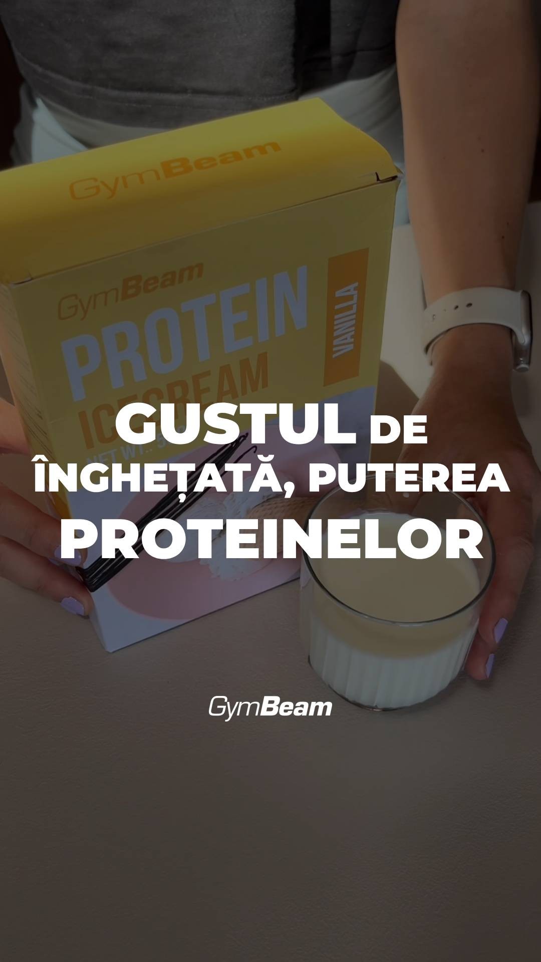 The image shows a person's hands holding a box of GymBeam protein ice cream, with a glass of vanilla ice cream and the brand name shown prominently. Text overlay displays the phrase 'GUSTUL DE ÎNGHEȚATĂ, PUTEREA PROTEINELOR'. The background is a neutral gray-brown surface.