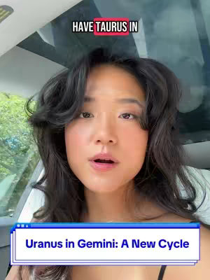 The image is a selfie-style video still featuring a young woman with long, dark, curly hair. She has light skin, and her expression is open-mouthed, as if she is speaking. The focus is on her face, positioned in the center; the background reveals the inside of a car, with a window showing a glimpse of greenery. Text overlays are present: a top label reading "HAVE TAURUS IN" with an inline box indicating the word 'TAURUS'; and a bottom label reading "Uranus in Gemini: A New Cycle."