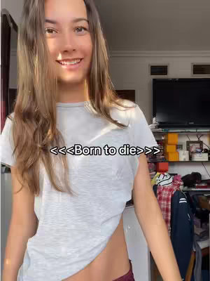 The cover image features a young woman smiling, with long, light brown hair. She's wearing a gray t-shirt, and a small part of a burgundy garment is visible. The background includes a window and some furniture.