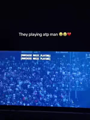 The cover image shows a large crowd of people, possibly at a sporting event or concert. The image is dark and has a blue tint. Text overlays the image, indicating that mariachi music is playing.