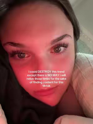 A close-up shot of a young woman's face. Her eyes are open and focused, with prominent eyelashes. She appears to be in a dim setting, possibly indoors, with reddish lighting adding a warm tone to her skin. The text overlay in the image describes the video's theme or content.