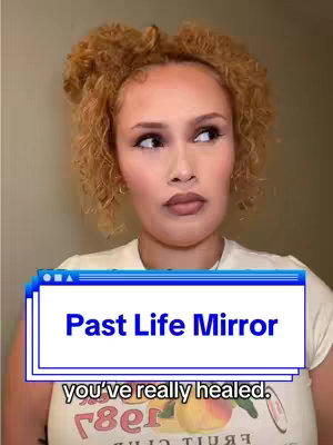 A woman with curly blonde hair is in a close-up shot, gazing slightly to her right with a contemplative expression. She is wearing a white t-shirt, and the background is a neutral, light-colored wall. Overlaying this image is a stylized text box with the words 'Past Life Mirror' and the partially visible text ' you've really healed.'