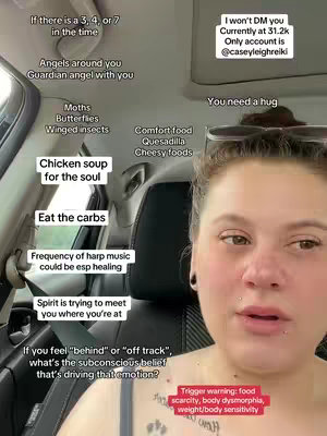 A selfie-style shot taken inside a car. The main subject is a woman with light skin, wearing a dark top and has multiple piercings on her face. The background includes parts of the car's interior, with text bubbles floating over different areas around the woman, containing various words or phrases, such as "Comfort food" and "Chicken soup". A trigger warning and Instagram handle is also present.