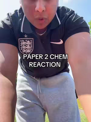 A selfie-style shot with the creator in the foreground, framed from the chest up. The person, wearing a dark polo shirt with a logo and the English football badge, is looking towards the camera. Text is overlaid on the image. The background is somewhat blurred, suggesting the outdoors.