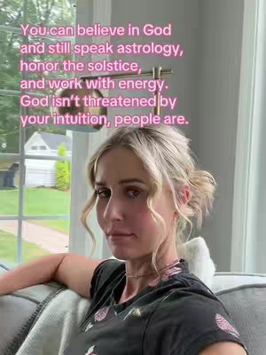 A woman with blonde hair sits on a couch, looking at the camera with a soft expression. The background includes a window with a view of trees and a house. Text in bubble letters overlays on the top of the image, in this shot.