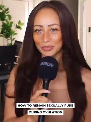 A woman with long brown hair, wearing a beige top, holds a black microphone with a RODE logo. The background is blurred, suggesting an indoor setting. Text overlay at the bottom reads 'HOW TO REMAIN SEXUALLY PURE DURING OVULATION'.